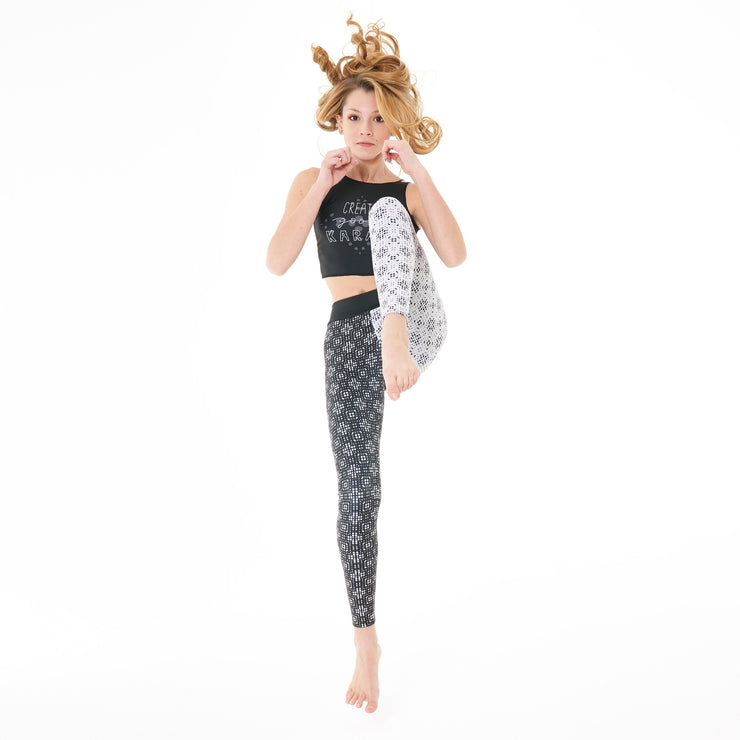 Karma leggings are perfect for kindness warriors. Abstract geometric print, 1 leg is white, other leg black.